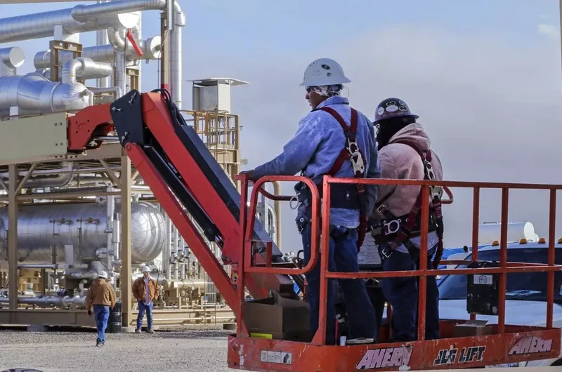 environmental portrait workers in hard hats on industrial boom lift