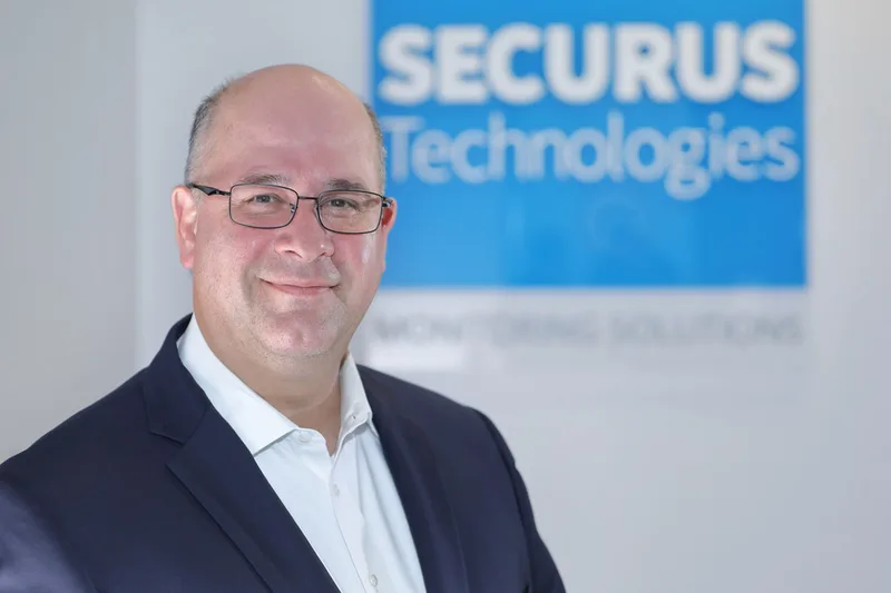Male executive headshot blue blazer Securus Technologies corporate office backdrop