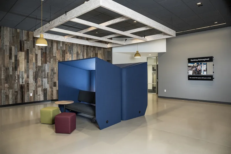 Capital One Bank lobby with acoustic privacy pod and reclaimed wood feature wall
