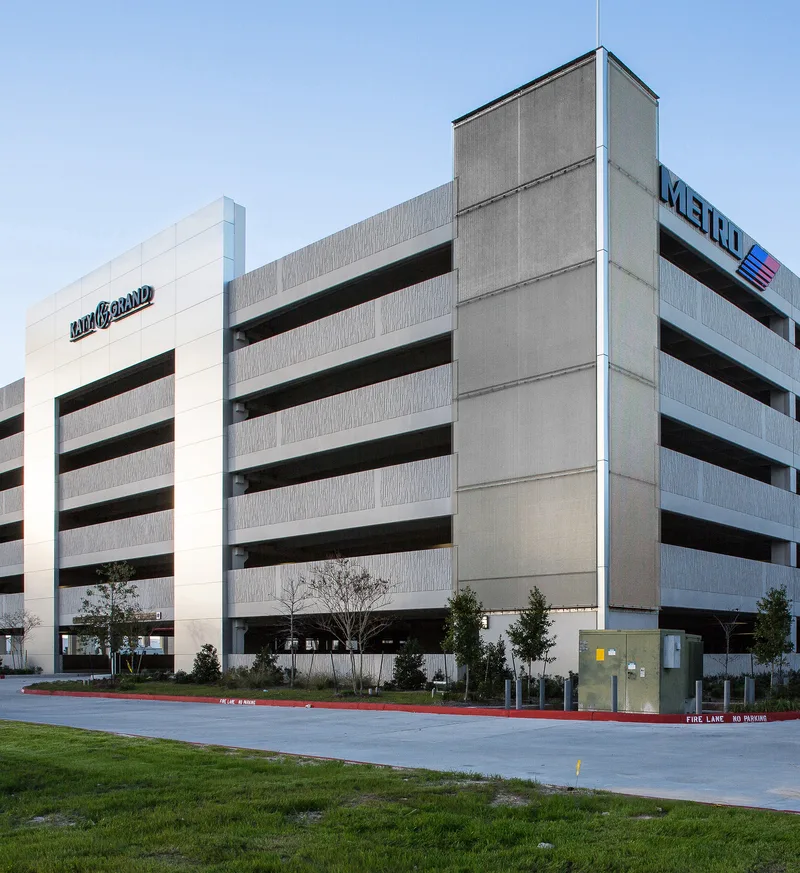 Metro parking structure with ribbed precast panels and brushed aluminum cladding