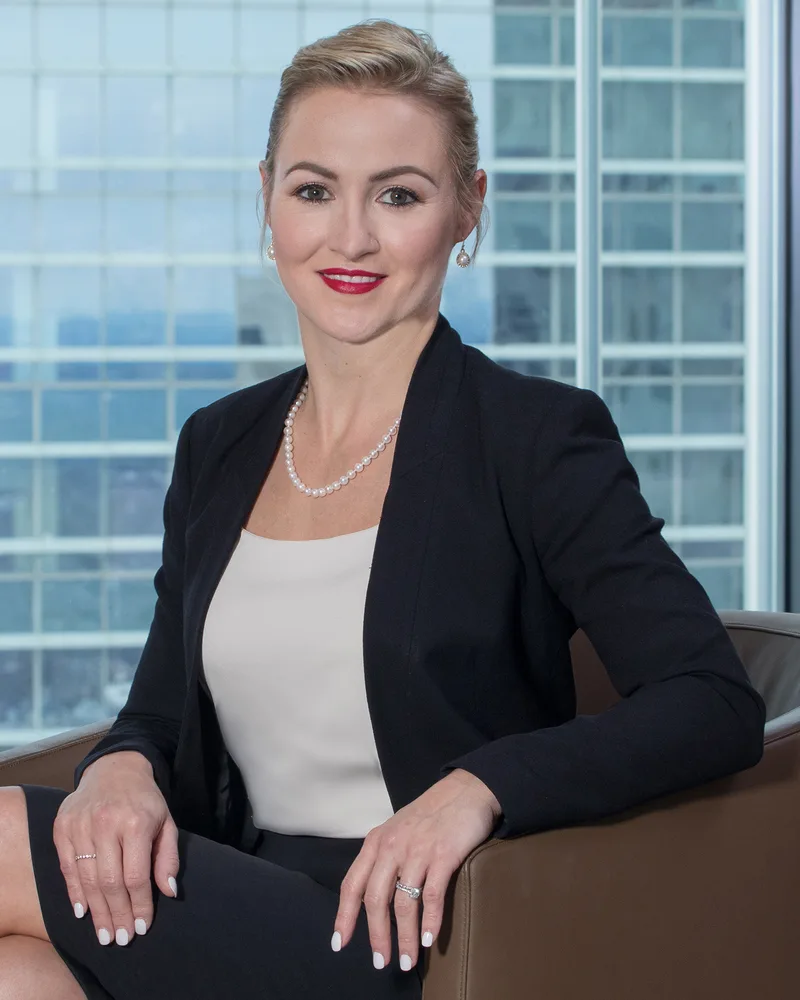 Executive headshot session showcasing professional woman in business attire against urban backdrop