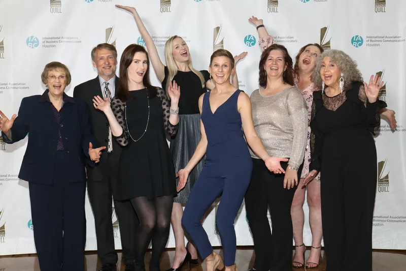 animated group of eight professionals celebrating at corporate awards ceremony backdrop
