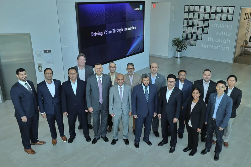 Corporate event group portrait executives in business suits modern innovation atrium