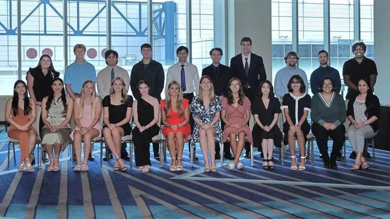 ILA scholarship award recipients posed in formal group portrait ceremony