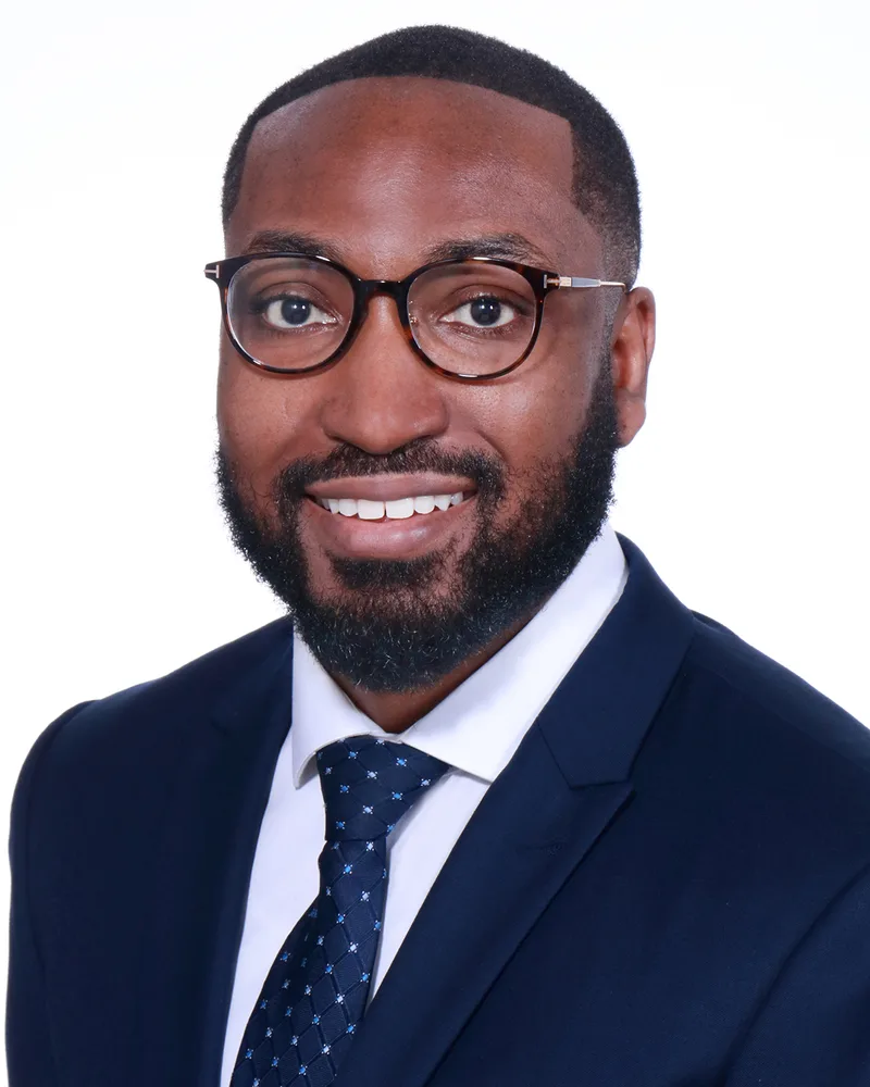 Washington Jarrett corporate headshot man navy suit patterned tie glasses