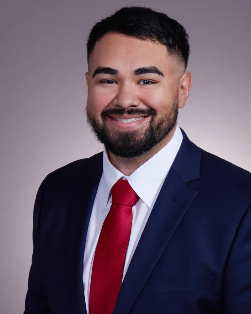Corporate headshot smiling man navy blazer white shirt red power tie