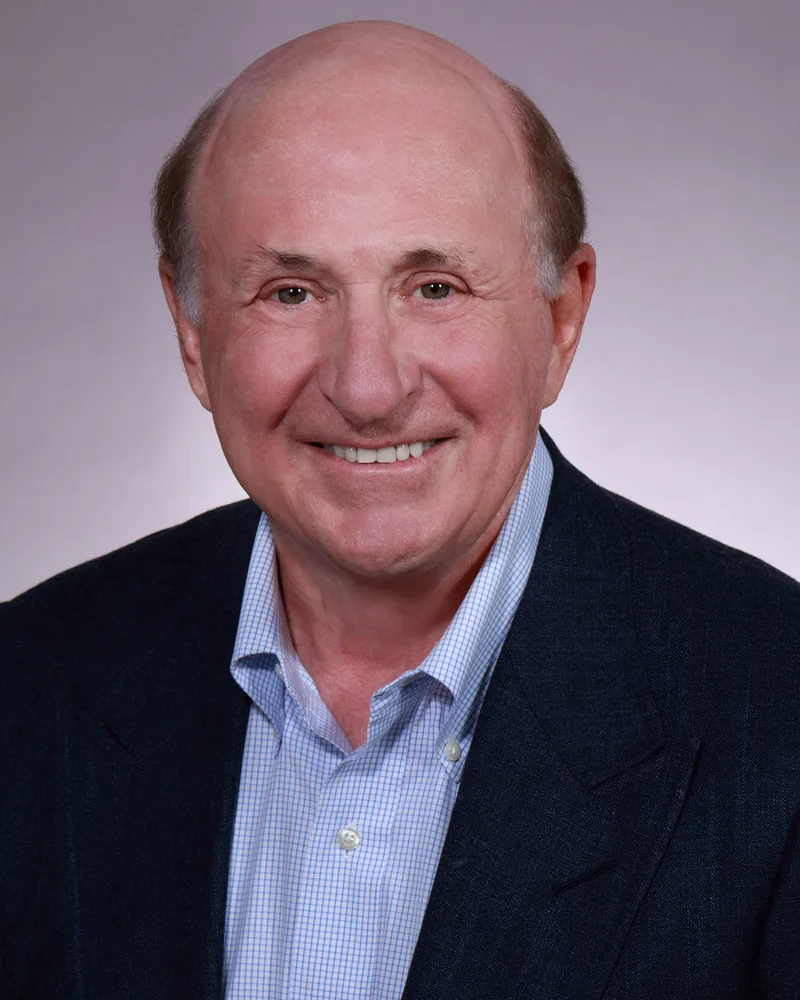 professional corporate headshot smiling man navy blazer light checkered shirt