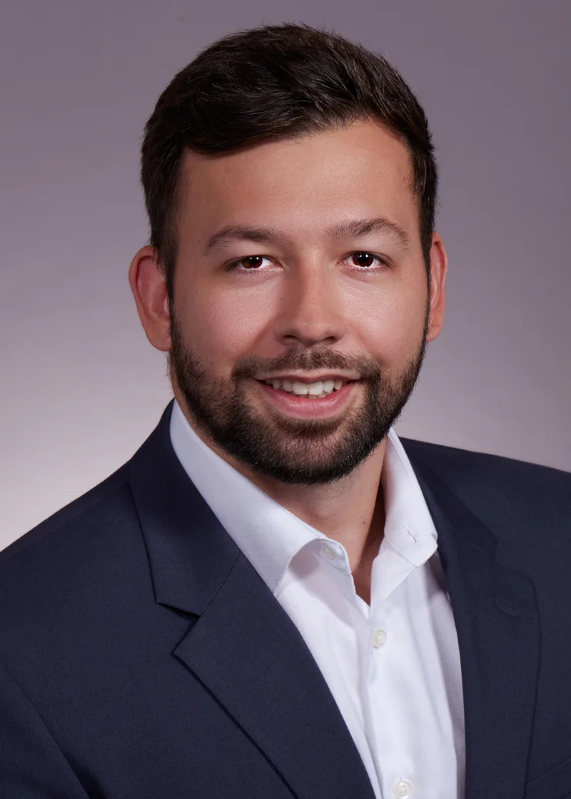 Business professional headshot smiling man navy blazer open-collar white dress shirt