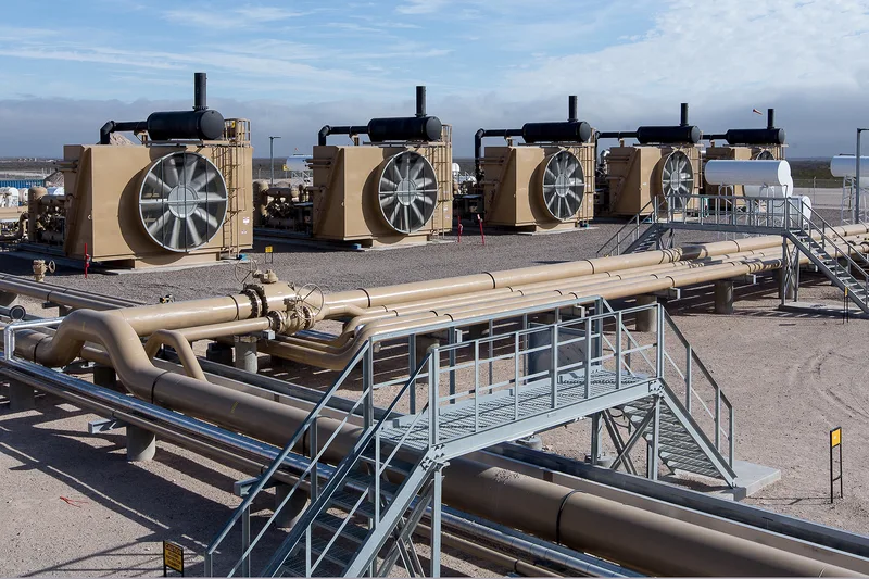 LNG compression station with tan air-cooled heat exchangers and steel pipeline infrastructure