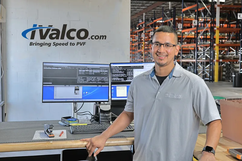 Corporate environmental portrait of oil field products delivery professional at industrial warehouse workstation