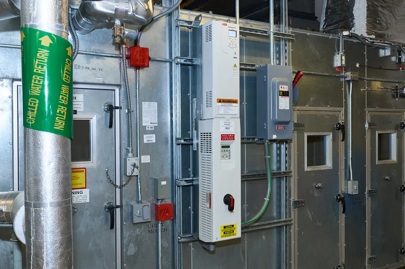 ABB variable frequency drive mounted on galvanized steel mechanical room wall