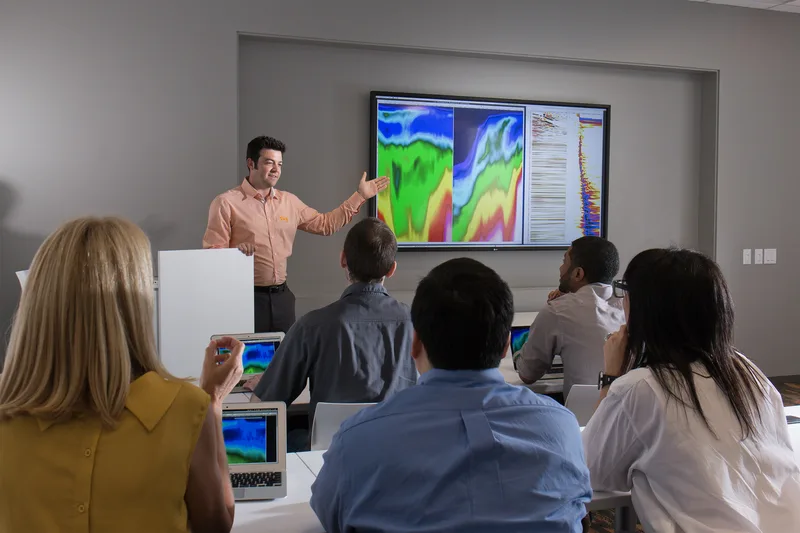 Corporate lifestyle training room presentation with seismic data visualization