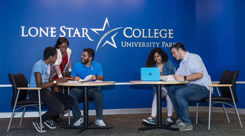 Lone Star College students collaborating over notes at modern round tables