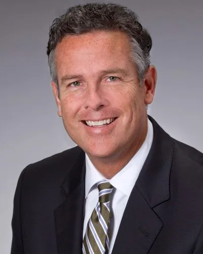 executive business headshot man in dark suit and patterned tie